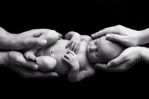 newborn-baby-in parents-hands