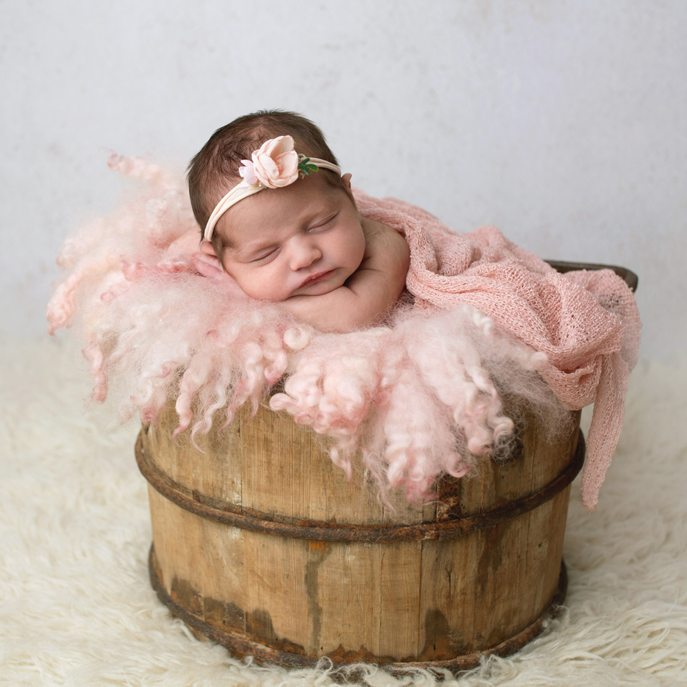 baby-sleeping-in-a wooden-bucket 